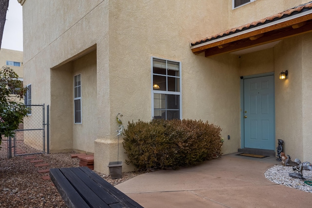 property entrance featuring a patio area