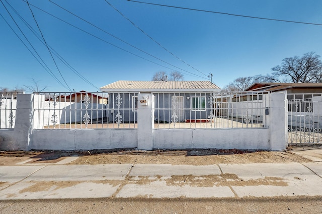 view of front of property with a fenced front yard and metal roof