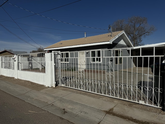 view of gate with a fenced front yard