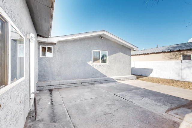 view of side of home featuring a patio area