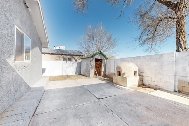 view of patio / terrace with a shed