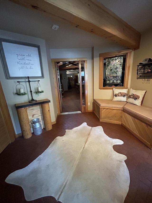 bedroom featuring beam ceiling and a closet