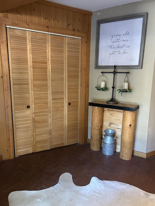 unfurnished bedroom with wooden walls and a closet