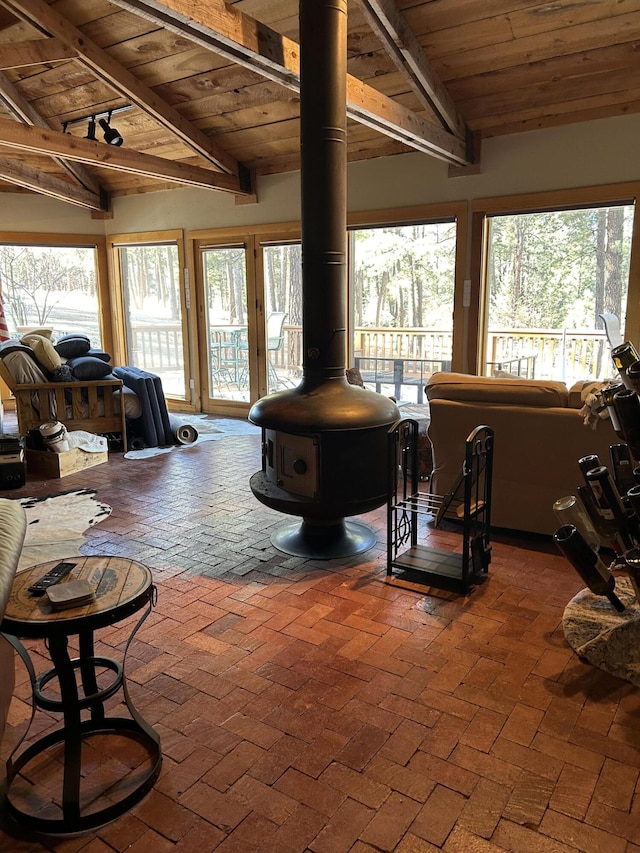 living room featuring lofted ceiling with beams and wood ceiling