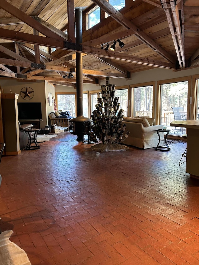 living room with high vaulted ceiling, wooden ceiling, and beam ceiling