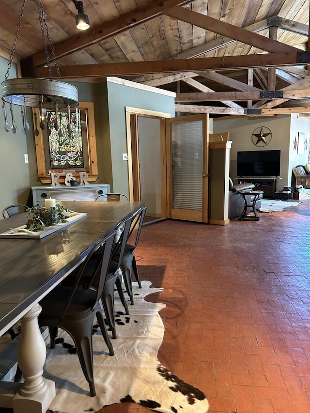 dining space featuring wood ceiling and lofted ceiling with beams