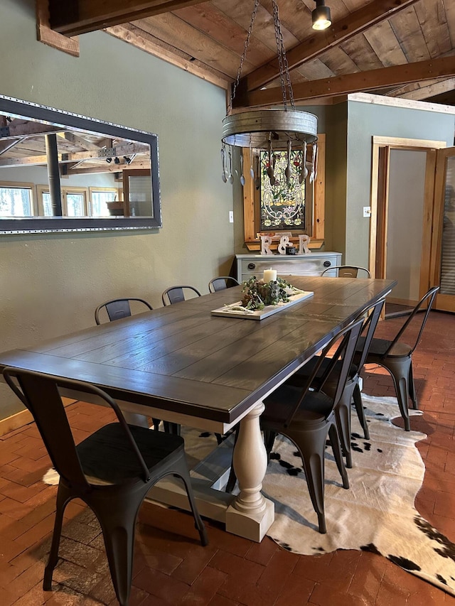 dining space featuring wooden ceiling and vaulted ceiling with beams