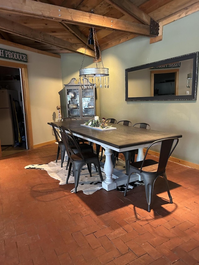 dining room featuring beam ceiling and wood ceiling