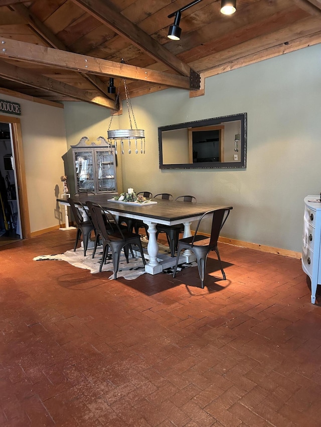 dining area featuring wooden ceiling, vaulted ceiling with beams, and rail lighting