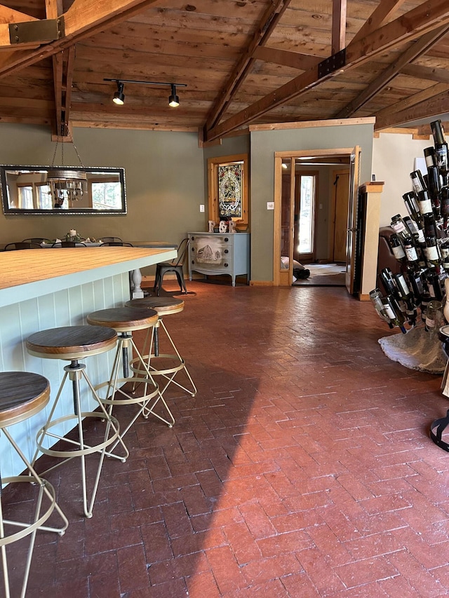 bar with wood ceiling and vaulted ceiling with beams