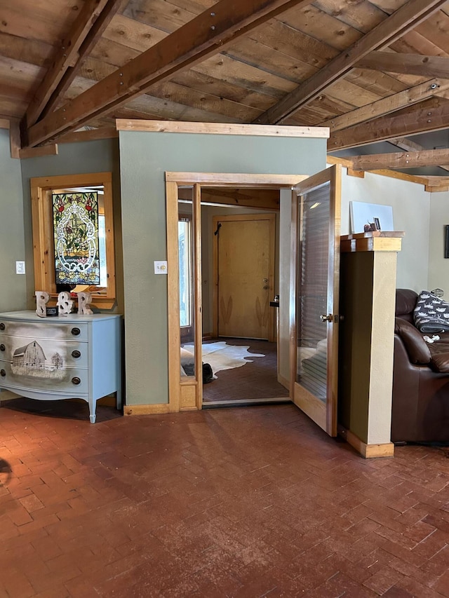 interior space featuring beam ceiling and wooden ceiling