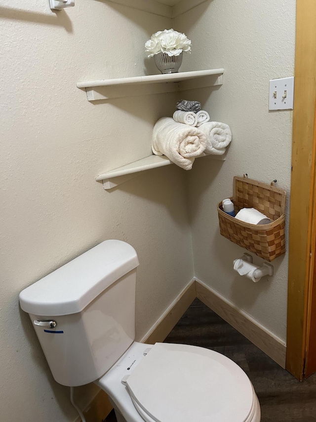 bathroom with toilet and wood-type flooring