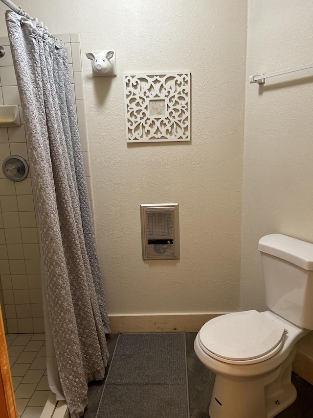 bathroom with walk in shower and toilet