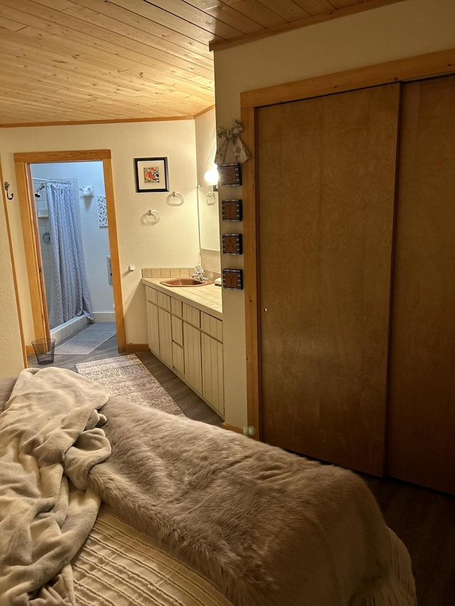 bedroom featuring wood ceiling, connected bathroom, ornamental molding, sink, and light hardwood / wood-style flooring