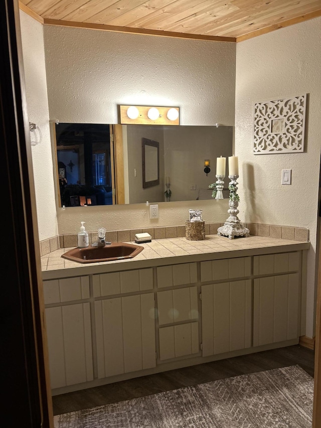 bathroom with wood ceiling and vanity