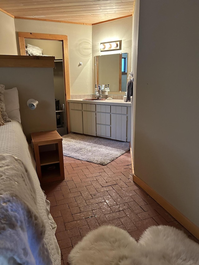 bathroom featuring vanity, wooden ceiling, and ornamental molding