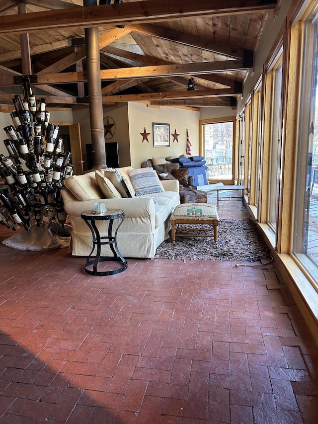 unfurnished sunroom with wooden ceiling and lofted ceiling with beams