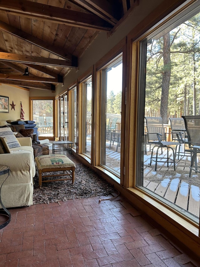 sunroom featuring wood ceiling and vaulted ceiling with beams