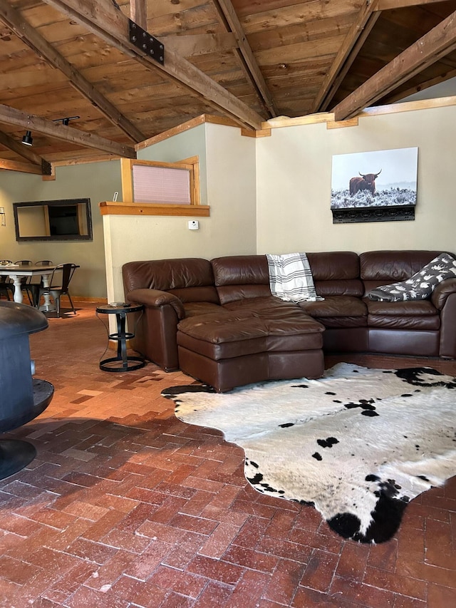 living room with wooden ceiling, a wood stove, and beamed ceiling