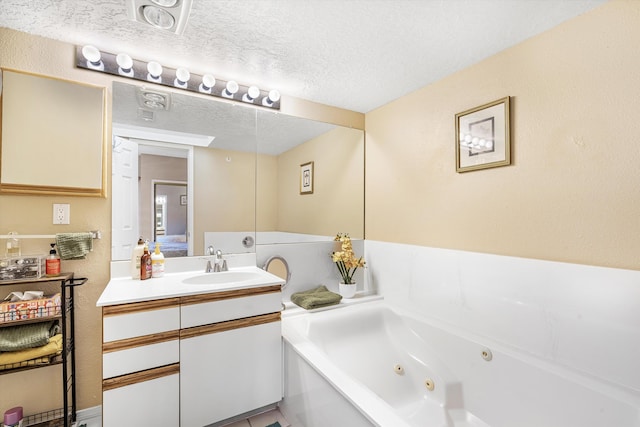 bathroom featuring vanity, a textured ceiling, and a bathing tub