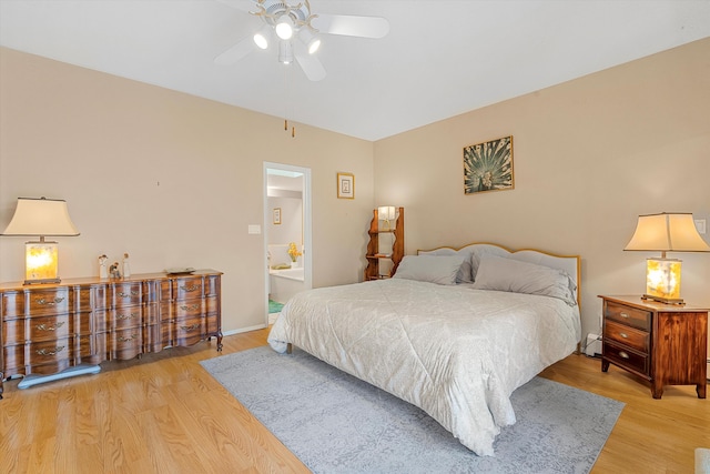 bedroom featuring ensuite bath and light hardwood / wood-style floors