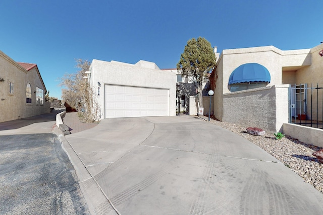 southwest-style home featuring a garage