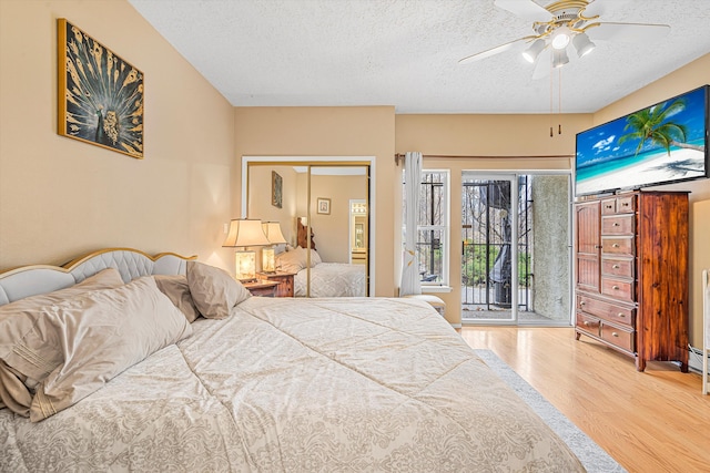 bedroom with wood-type flooring, a textured ceiling, access to outside, a closet, and ceiling fan