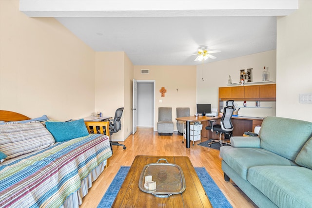 living room with light hardwood / wood-style floors and ceiling fan