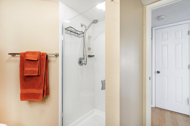 bathroom with toilet and a shower