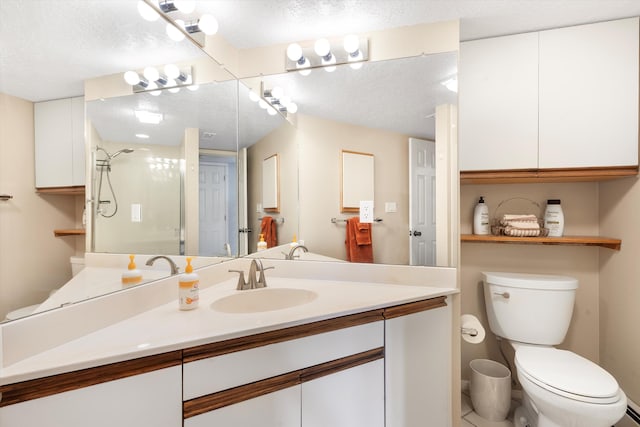 bathroom featuring vanity, toilet, a textured ceiling, and walk in shower