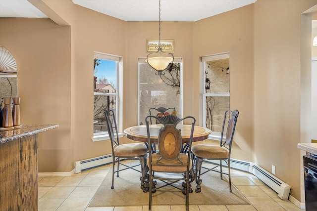 dining space featuring a baseboard heating unit and light tile patterned flooring