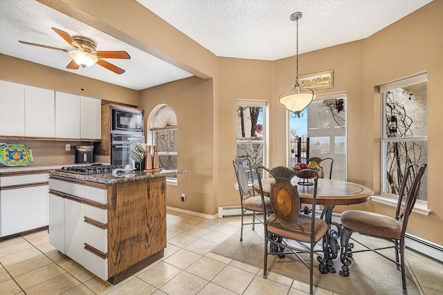 kitchen featuring white cabinetry, hanging light fixtures, a center island, light tile patterned floors, and black appliances