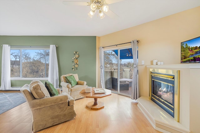 sitting room featuring hardwood / wood-style floors, a wealth of natural light, and ceiling fan