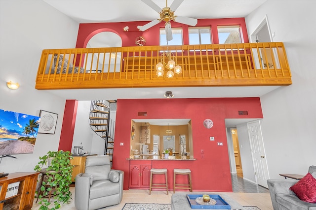 tiled living room with a towering ceiling and ceiling fan