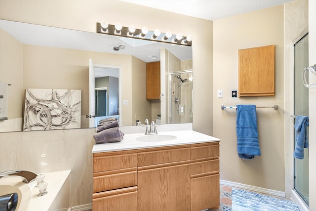 bathroom with vanity and a shower with door