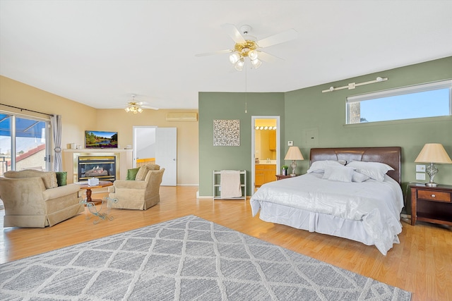 bedroom featuring ceiling fan, hardwood / wood-style floors, and access to outside