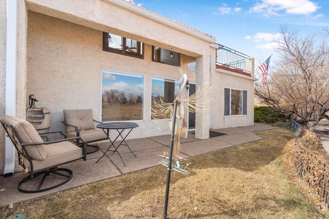 back of property featuring a balcony