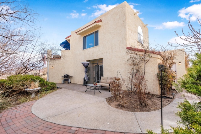 rear view of property featuring a patio