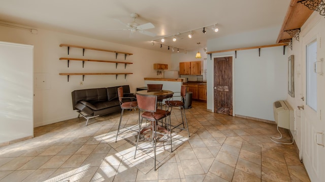 dining area featuring radiator and ceiling fan