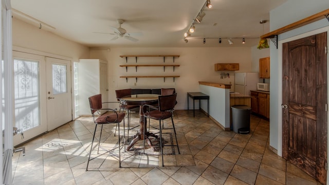 dining space featuring french doors and ceiling fan