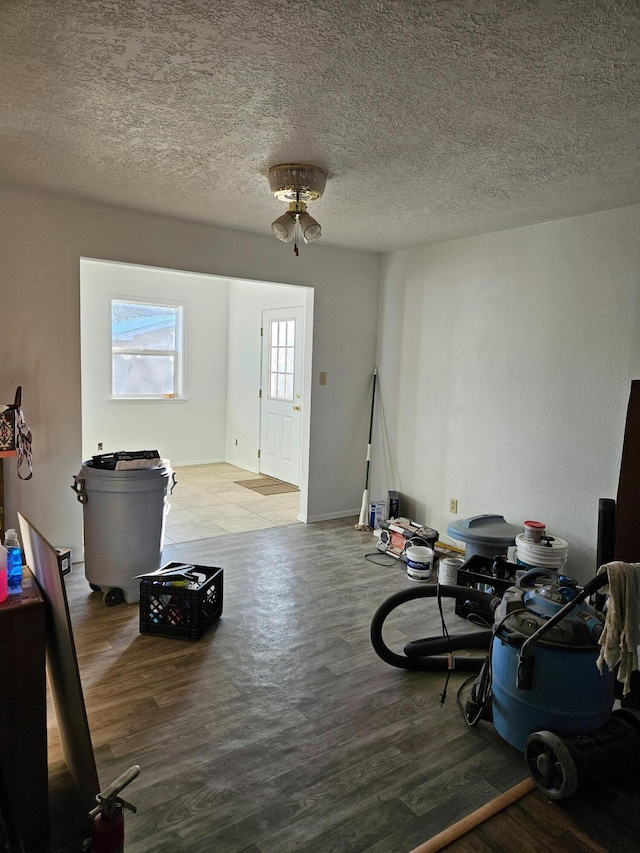 misc room with a textured ceiling and wood finished floors