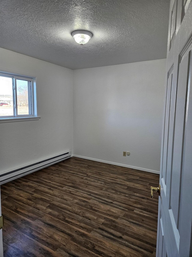 empty room with a baseboard radiator, a textured ceiling, baseboards, and dark wood-type flooring