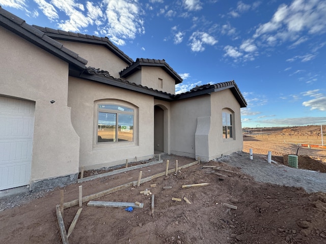 view of side of property featuring a garage