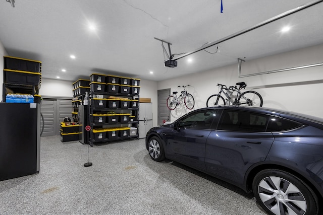 garage with a garage door opener and recessed lighting