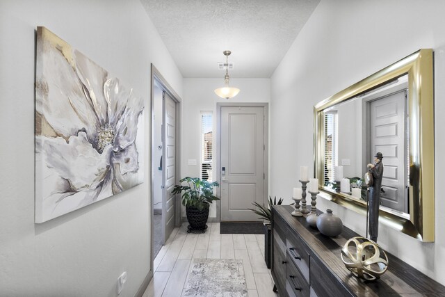 foyer entrance featuring a textured ceiling