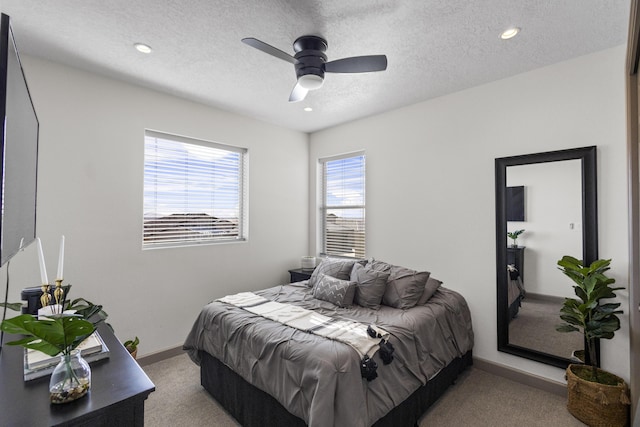 bedroom with a textured ceiling, recessed lighting, carpet flooring, a ceiling fan, and baseboards