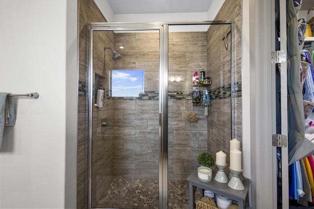 bathroom featuring a shower with shower door