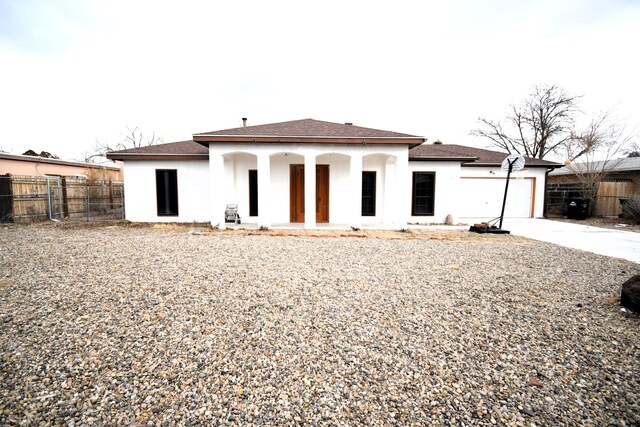 rear view of house with a garage