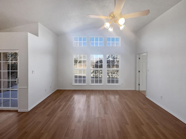 unfurnished living room featuring dark hardwood / wood-style flooring, ceiling fan, and lofted ceiling