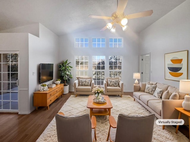 living room with dark hardwood / wood-style floors, ceiling fan, and vaulted ceiling